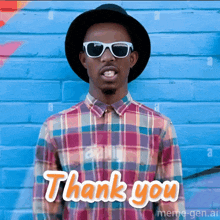 a man wearing a plaid shirt and a hat says thank you