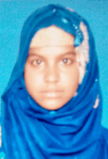a woman wearing a blue scarf on her head