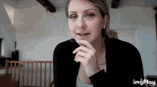 a woman 's face is shown in a gif with imgplay at the bottom