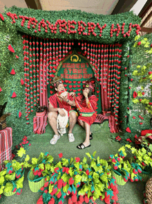 two people are sitting in front of a sign that says " strawberry day "