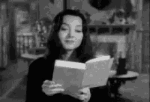 Morticia Addams GIF - Morticia Addams Reading GIFs