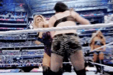 a woman is wrestling another woman in a ring .