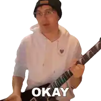 a man holding a guitar with the word okay written on the bottom
