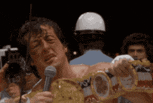 a man is holding a boxing belt that says ' heavyweight ' on it