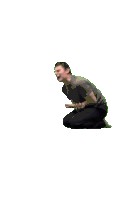a man in a grey shirt is kneeling down and laughing