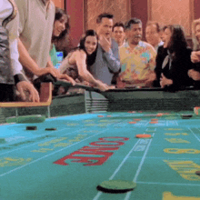 a group of people are playing a game of craps and the word come is on the table