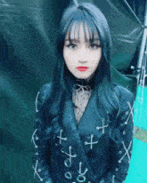 a girl wearing a black jacket with x 's on it