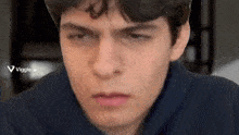 a close up of a young man 's face with a viggle.ai logo in the corner