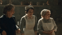 a woman in an apron is talking to a man