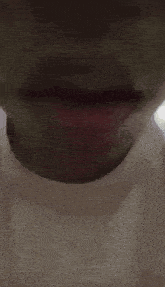 a close up of a person 's mouth with a red lipstick on .