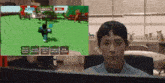 a man sitting in front of a computer with a screen that says garden and sell