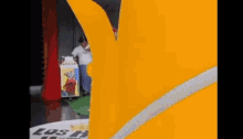a cartoon character is standing in front of a sign that says los angeles on it .