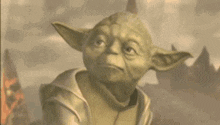 a close up of yoda from star wars looking up at the sky .