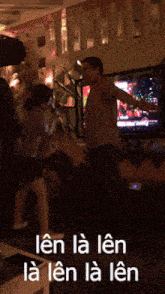 a group of people are dancing in front of a tv with the words len la len la len on the bottom