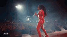 a woman in a bikini is dancing on a stage with a sign that says cancelella