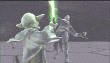 yoda is holding a green light saber while fighting a man .