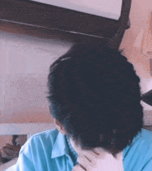 a close up of a person covering their face with their hand .
