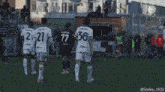 a soccer player wearing the number 36 jersey holds up his hand