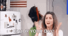 a woman is crying in front of a refrigerator with the words `` enjoy your day '' on it .
