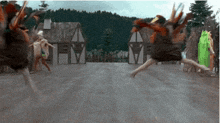 a group of people are jumping in the air in front of a sign that says m