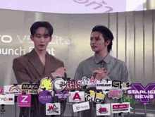 two men are standing in front of a sign that says all area entertainment