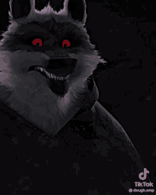 a close up of a wolf 's face with red eyes and teeth .