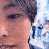 a close up of a person 's face with a blurry background