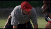 a man wearing a red hat and a gray shirt