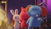 a group of stuffed animals standing in front of a live sign