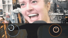 a woman is smiling in front of a computer screen with a mouse and a keyboard