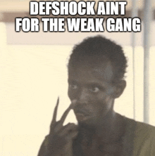a man with his finger in his nose and the words defshock aint for the weak gang above him