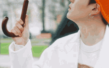 a person holding an umbrella in their right hand