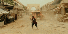 a man stands in front of a burning carriage