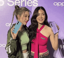 two women are posing for a picture in front of a sign that says opp series
