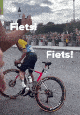 a man riding a bike with the word fiets written on the bottom