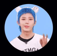 a person with blue hair wearing a tmg t-shirt