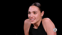 a woman in a black tank top is standing in front of bottles and a sign that says fast n easy