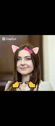 a woman wearing cat ears and a bow on her head is pointing at something