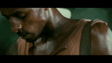 a close up of a man 's neck and shoulder with sweat coming out of it .