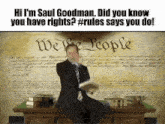 a man in a suit and tie is holding a piece of paper in front of a we the people sign