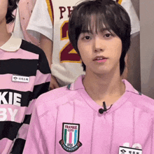 a boy wearing a pink franklin city shirt