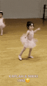 a little girl in a tutu is dancing with the words kaylah & nikki 1992