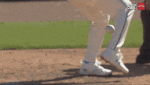 a baseball player is getting ready to throw the ball while a stream cubs logo is visible in the background