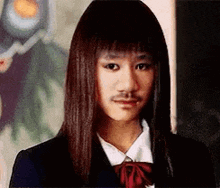 a young woman with long hair and a mustache is wearing a school uniform .