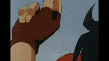 a close up of a person 's hand reaching up in the air .