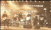 a group of people playing guitars on a stage with a sign that says ccc