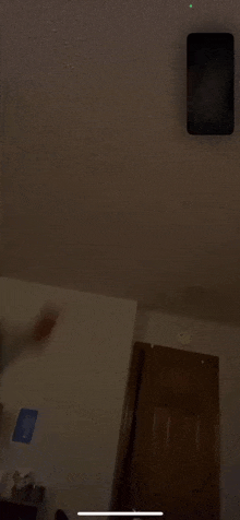 a person is holding a cell phone in a dark room .