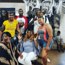 a group of people posing for a picture with one woman wearing a yellow shirt that says saturday