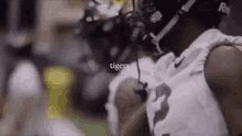 a close up of a football player wearing a helmet and headphones on a field .
