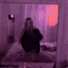 a woman taking a selfie in front of a mirror